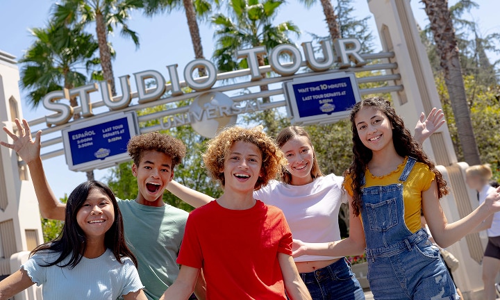 Kids posing in front of the Studio Tours sign