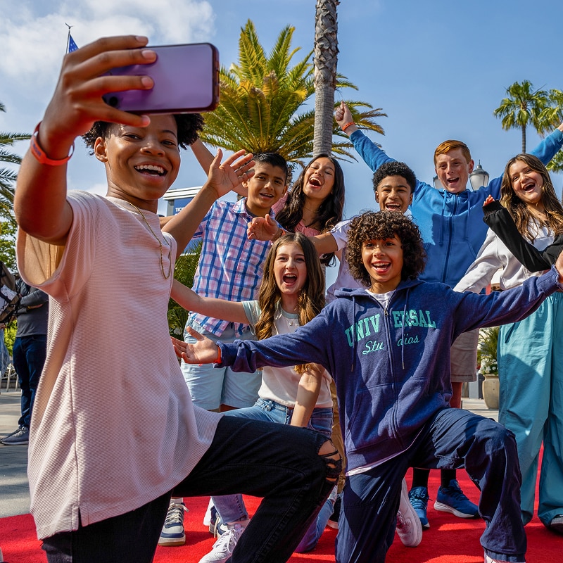 Kids taking a selfie in front of the Universal Studios Hollywood Entrance Sign