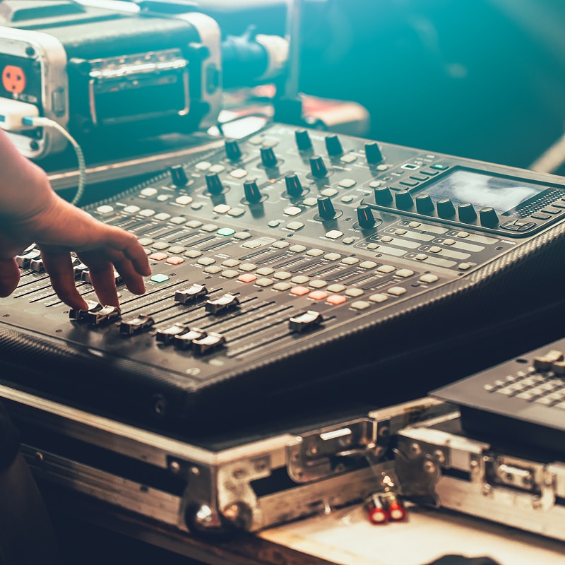 A man and woman operating a soundboard