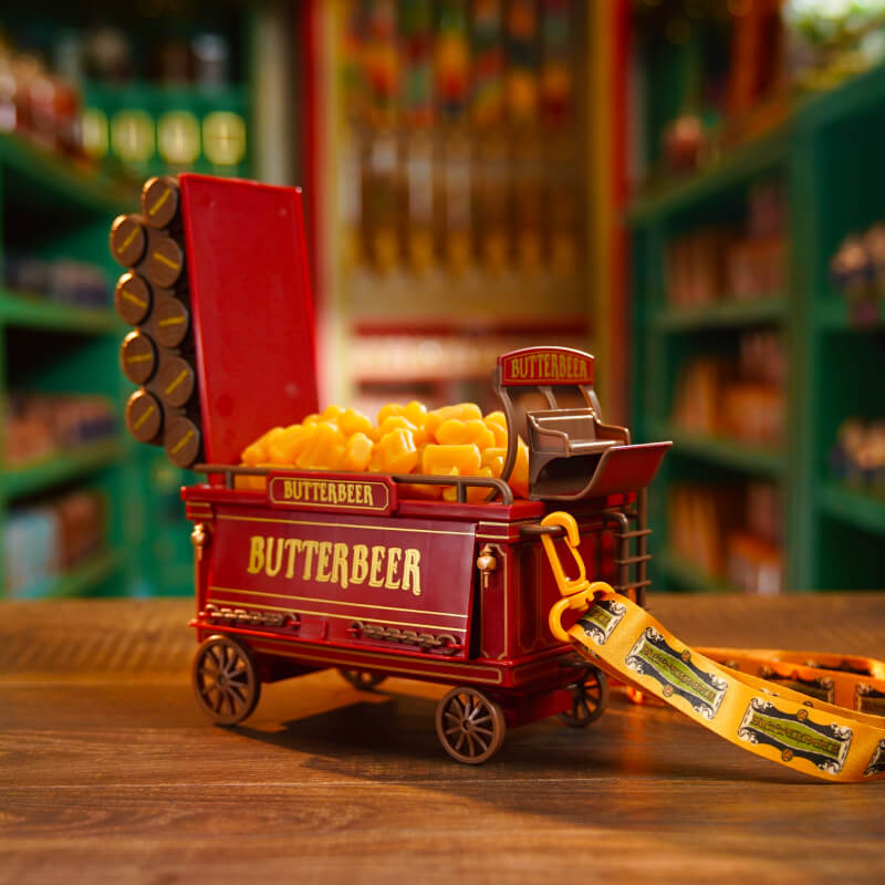 Up-close shot of Butterbeer™ Gummies with a Souvenir Butterbeer™ Cart