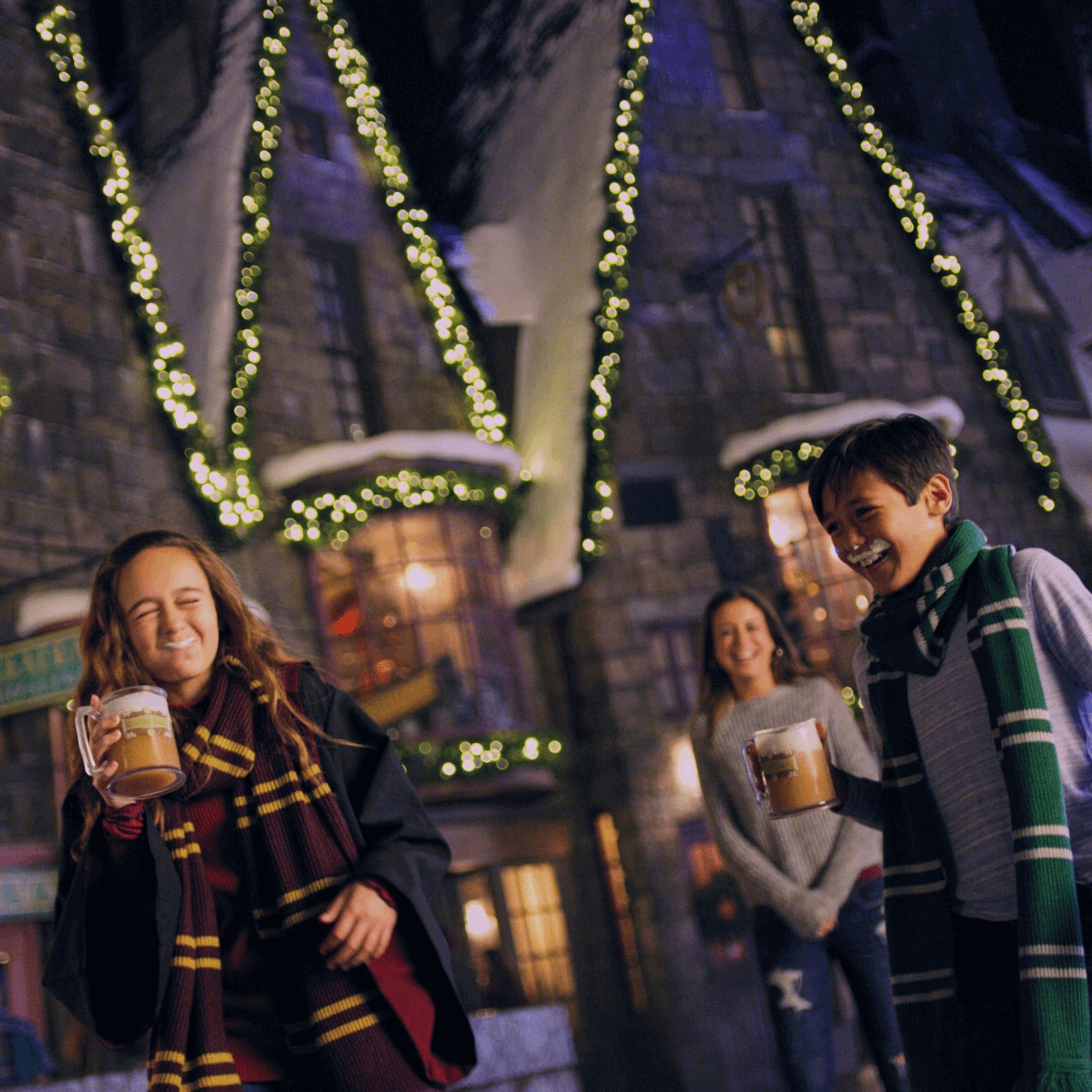 Hogsmeade village, all decorated and lit up for Christmas in the Wizarding World of Harry Potter.