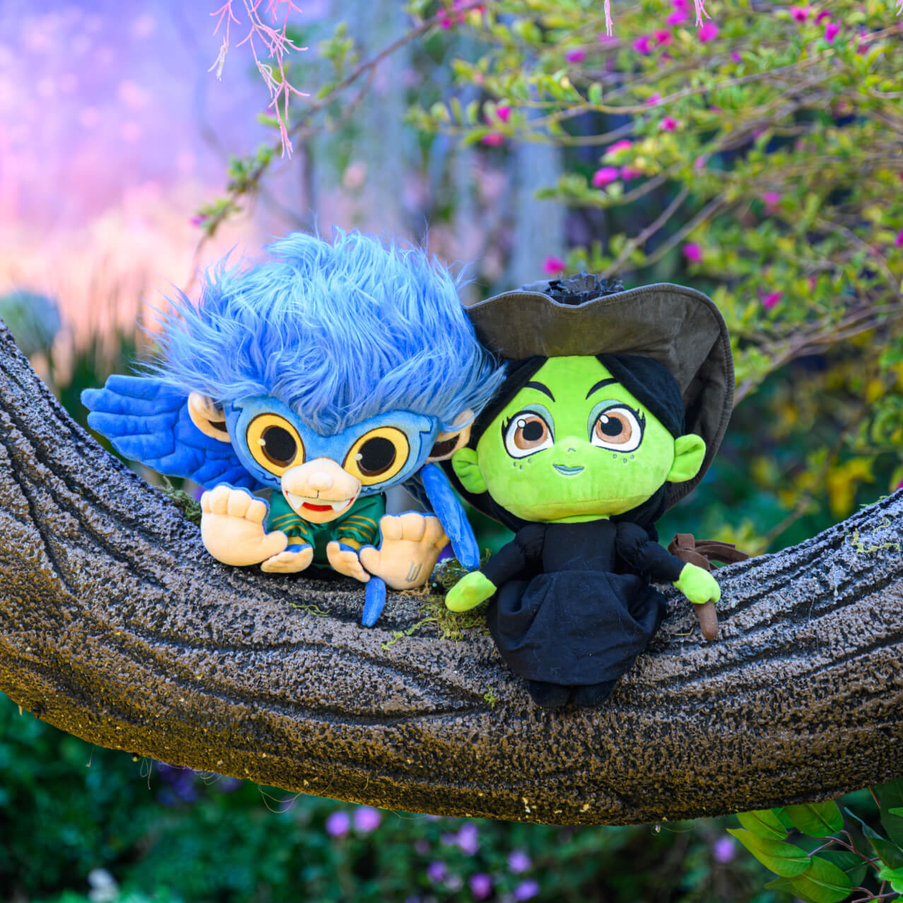 Wicked: For Good merchandise including two plushies resembling Elphaba and a flying monkey.