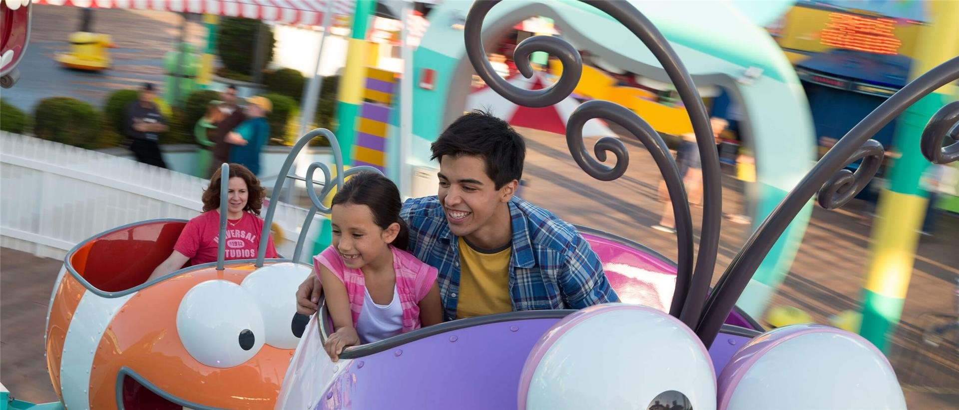 A young boy and girl on a Super Silly Fun Land ride.