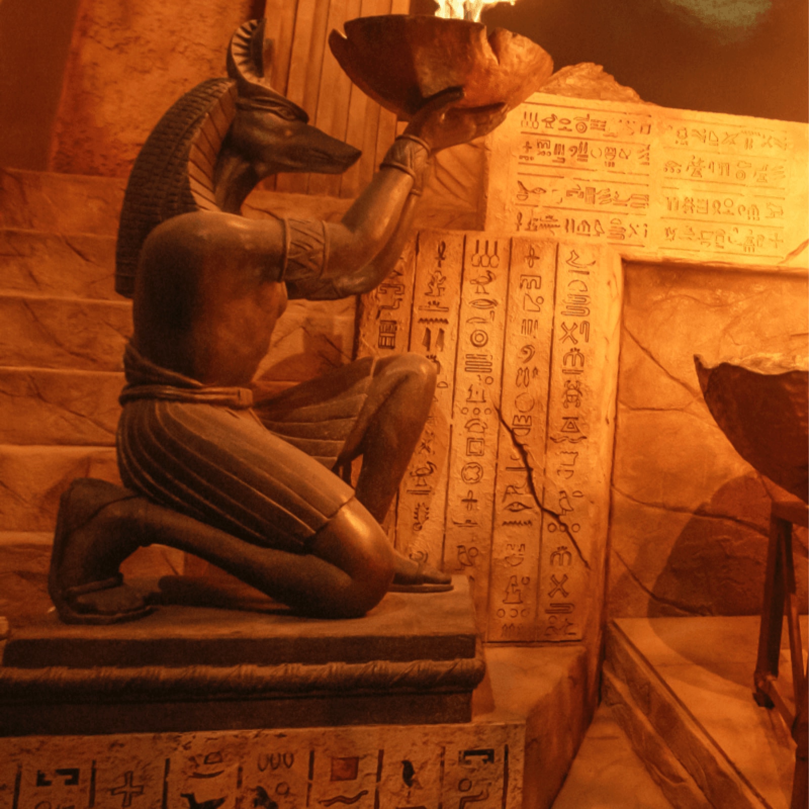 A stone room with a glass figure in a glass case that's placed in the middle of the room.
