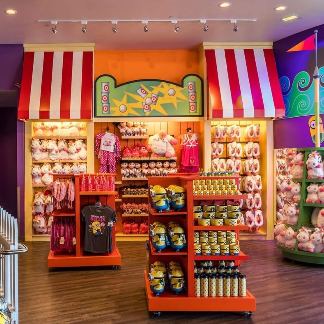 A retail store with minion and unicorn product and purple walls.