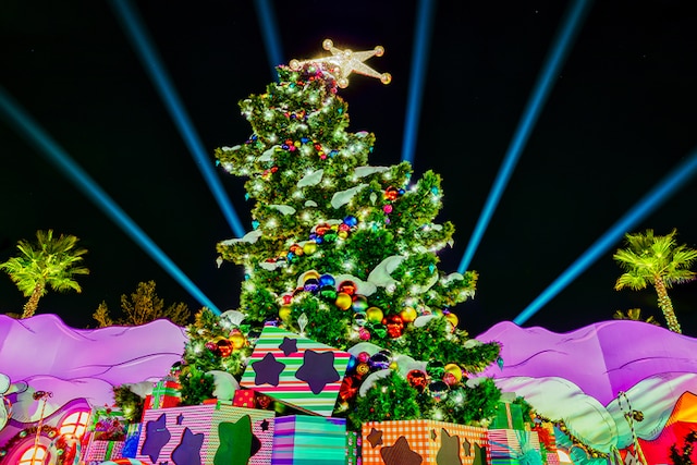 A sixty-five foot tall Christmas tree adorned with ornaments with a star on top.