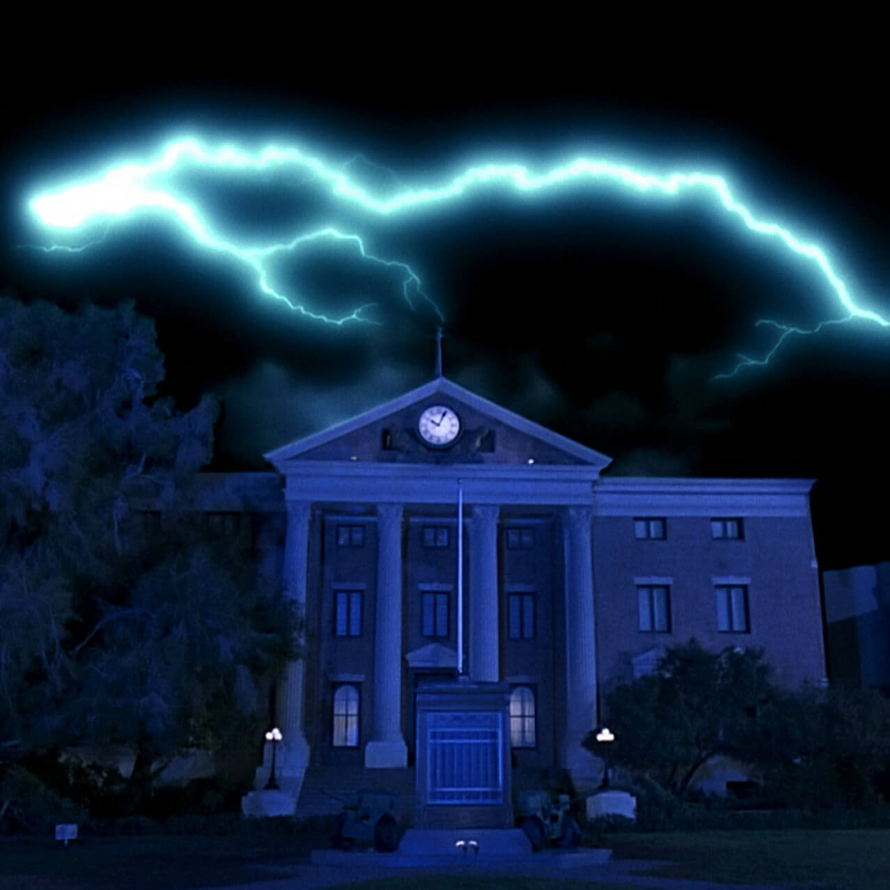 A lightning bolt amongst a night sky strikes the clock tower from Back to the Future.