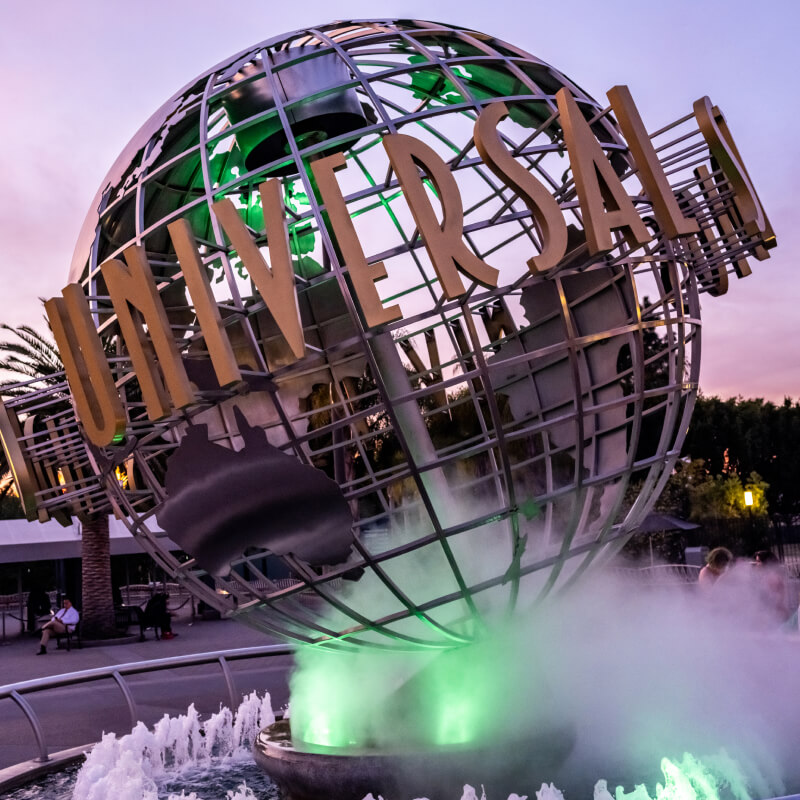 The Universal Studios Hollywood globe fountain with neon green mist below.