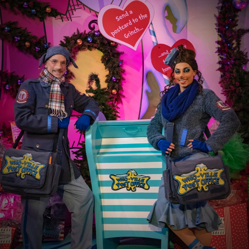 Two mail Whos in Who-ville smiling with sweaters.