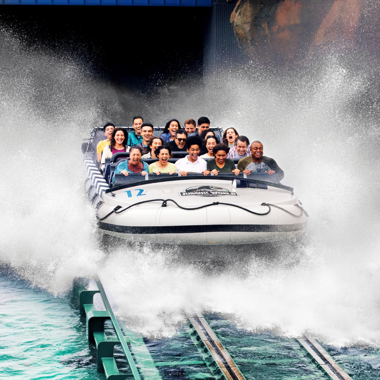 Guests reacting in excitement as they plunge down the waterfall drop on Jurassic Park - The Ride at Universal Studios Hollywood.