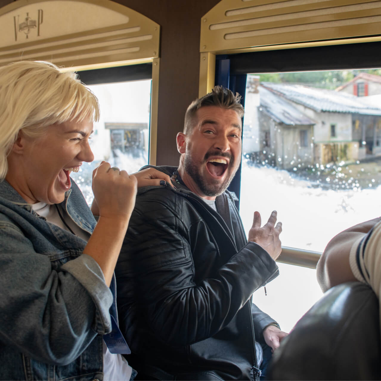 Guests laugh while getting shows a flood simulation on their VIP experience tour. 