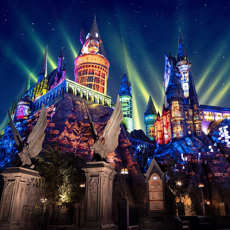 Colorful nighttime lights shine across Hogwarts™ Castle at Universal Studios Hollywood.